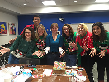 a group of residents show off dusty hands after making a gingerbread house