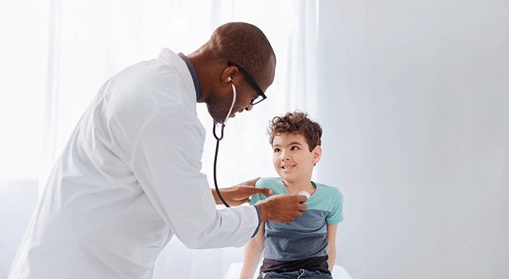 doctor examining young boy