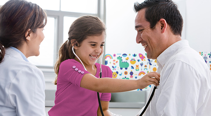 young girl laughing with doctor